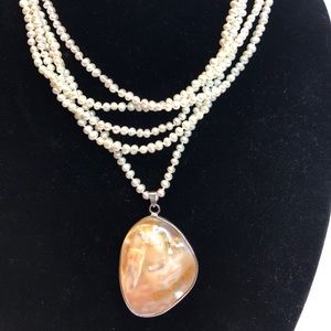 Multi strand freshwater pearl necklace with large mother of Pearl drop
